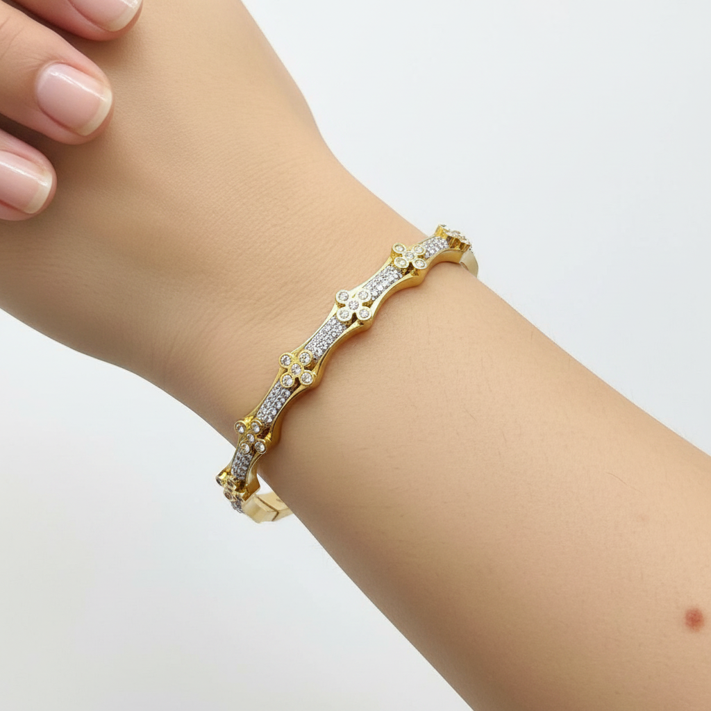 Model wrist wearing gold wavy crystal bangle bracelet