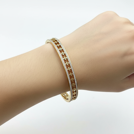 Model wrist wearing gold floral crystal bangle bracelet